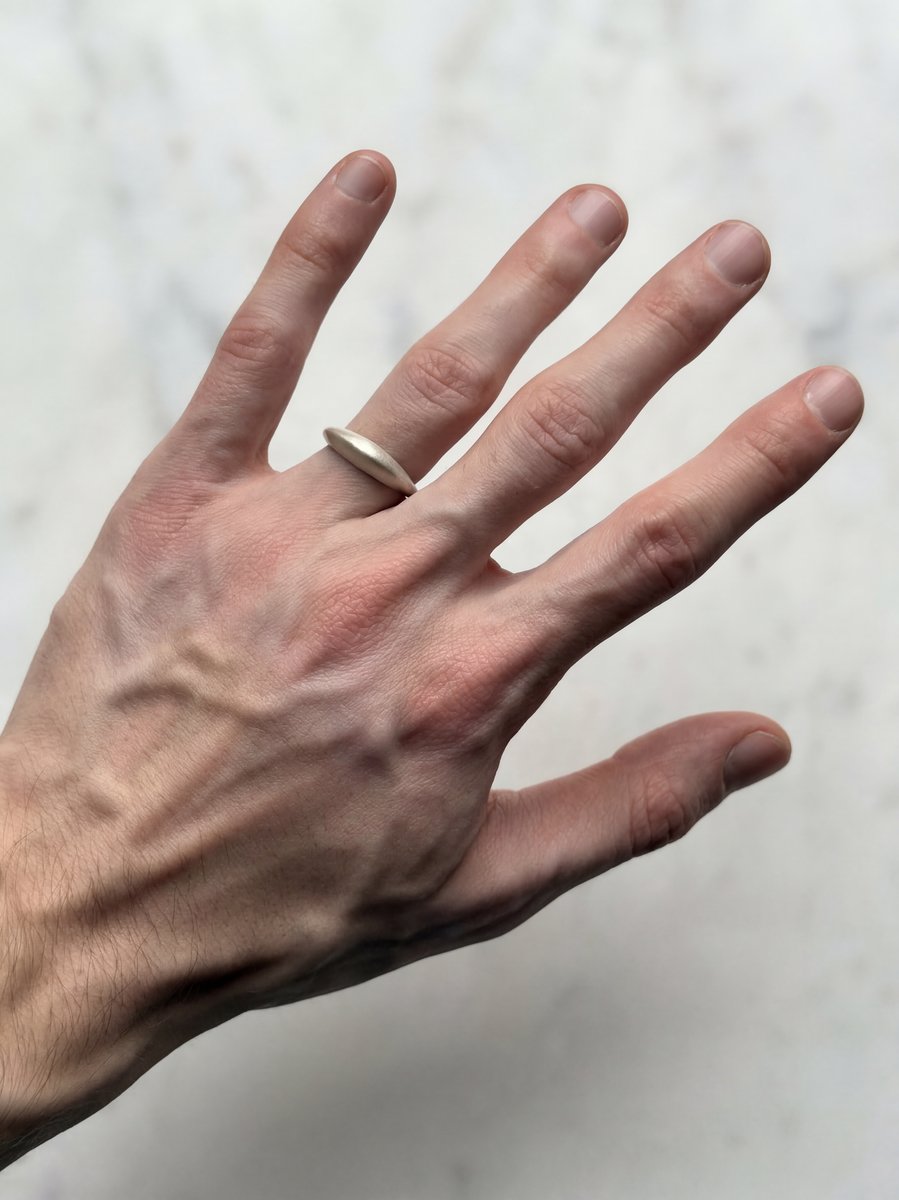 R.01 recycled sterling silver ring by Skorik Studio, worn on hand.